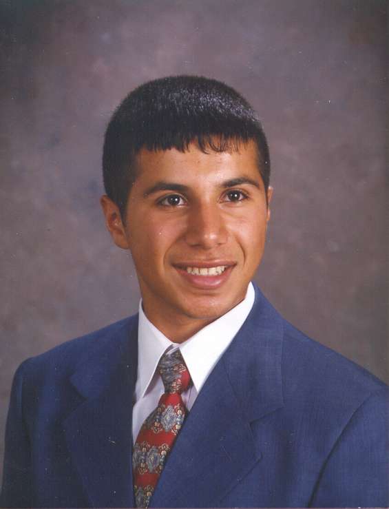 Farid - head shot in suit smiling