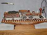 Picture of The Commodore Vanderbilt one of the trains Mr. Warther carved. Also, knife and tools he used in background.
