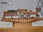 Picture of The Commodore Vanderbilt one of the trains Mr. Warther carved. Also, knife and tools he used in background.