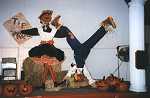 Stage display of Square Dancing scarecrows with male partner doing a somersault.
